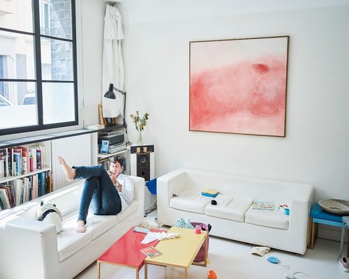 Person relaxing and stretching arms in a bright living room